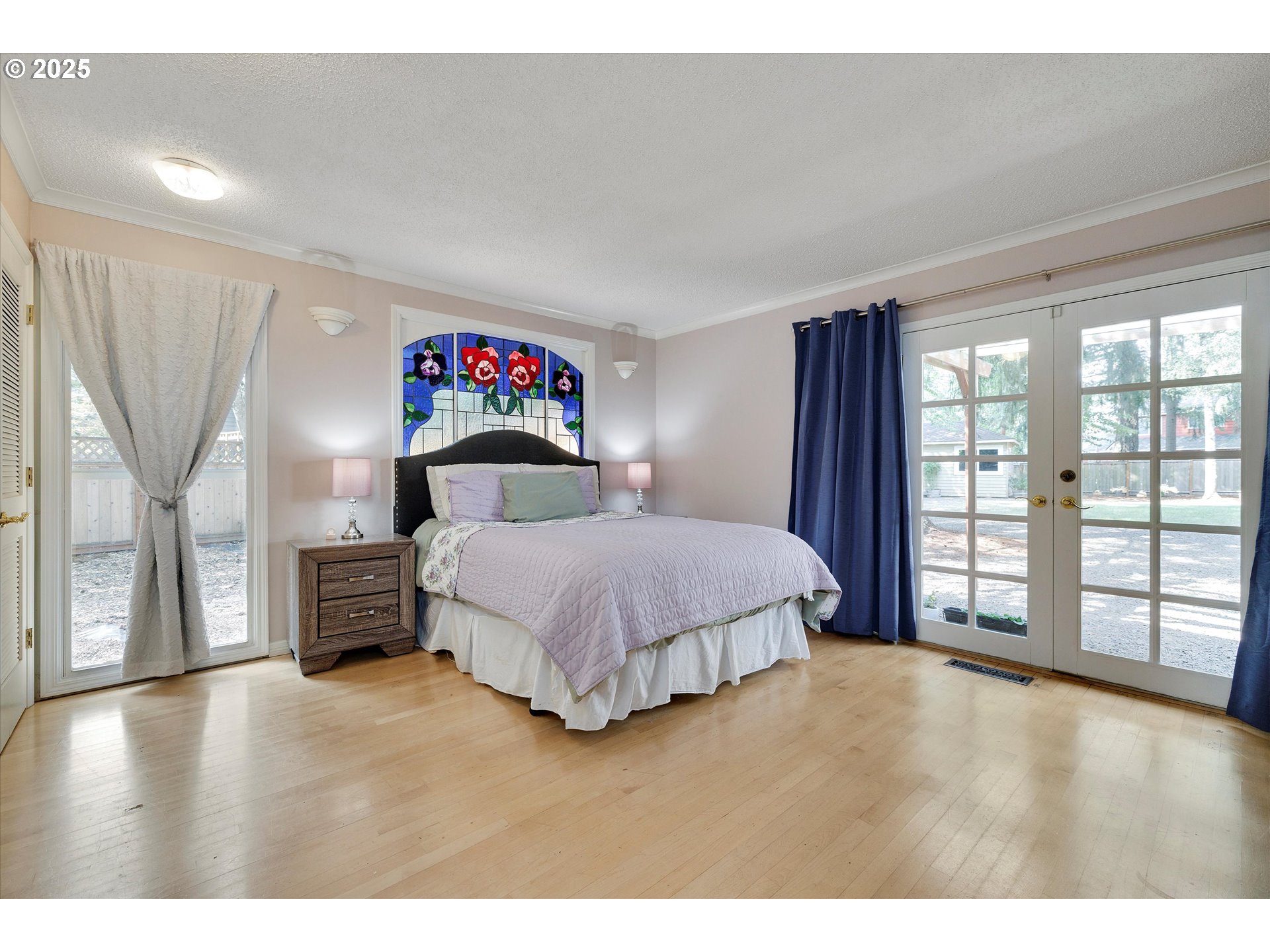 8815 Southwest Oleson Road Portland, OR 97223 - Photo 17 of 46 a spacious bedroom with a bed and a large window