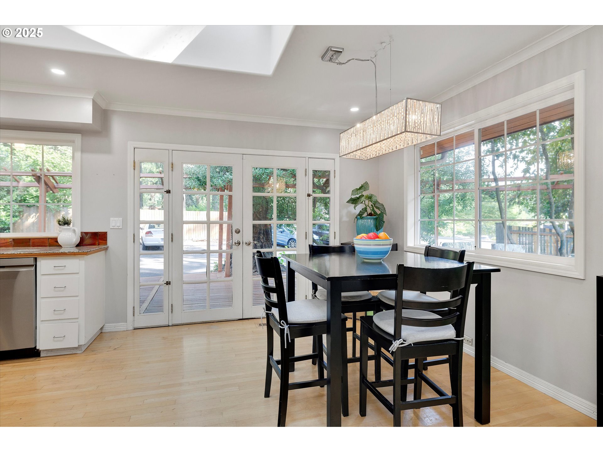 8815 Southwest Oleson Road Portland, OR 97223 - Photo 19 of 46 a view of a dining room with furniture large windows and wooden floor