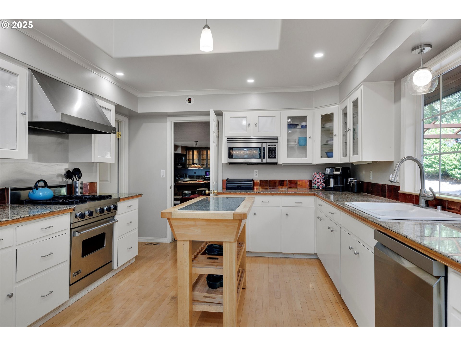 8815 Southwest Oleson Road Portland, OR 97223 - Photo 22 of 46 a kitchen with a sink window and stainless steel appliances
