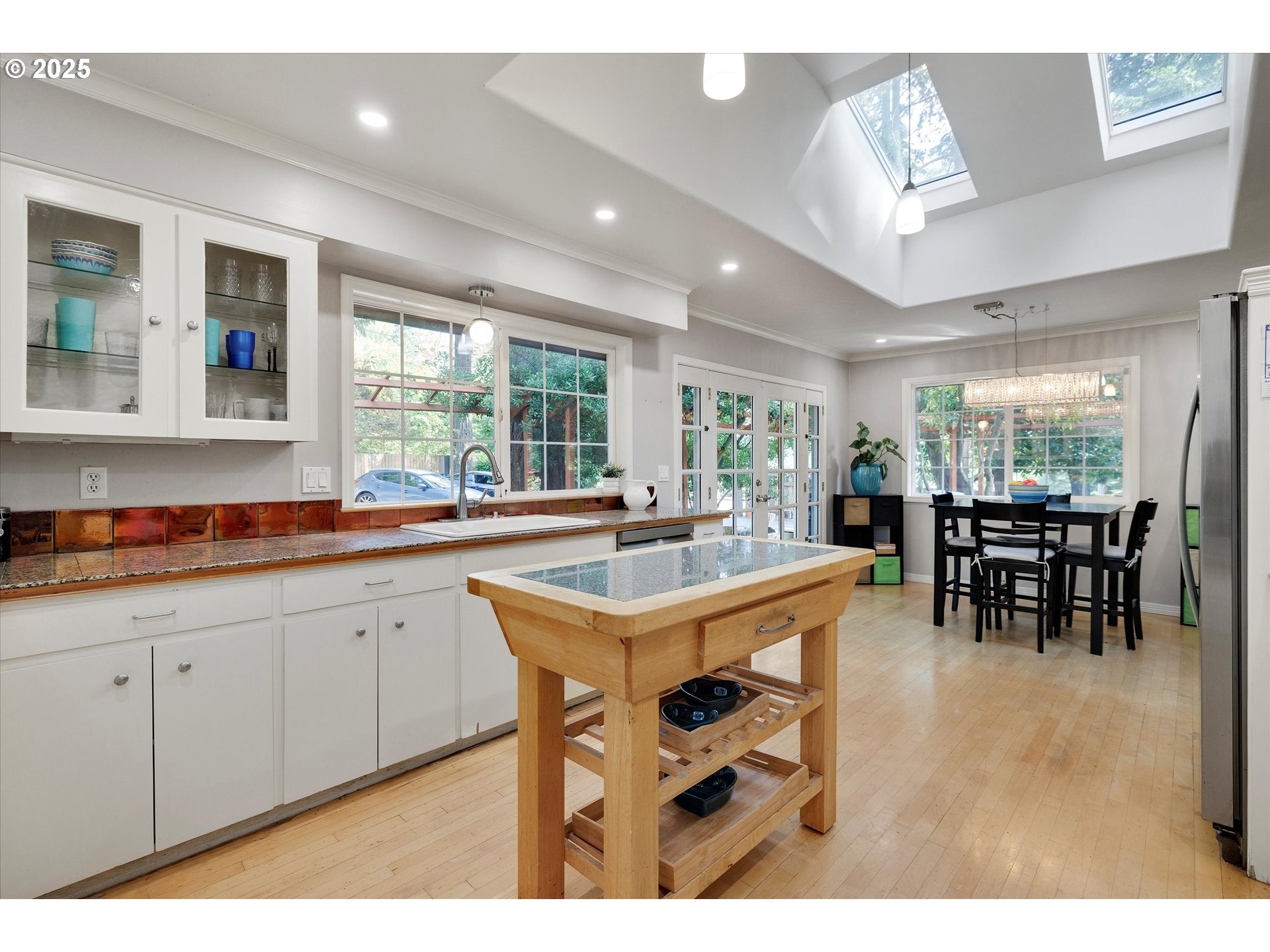 8815 Southwest Oleson Road Portland, OR 97223 - Photo 24 of 46 a open kitchen with stainless steel appliances granite countertop a dining table chairs and granite counter tops