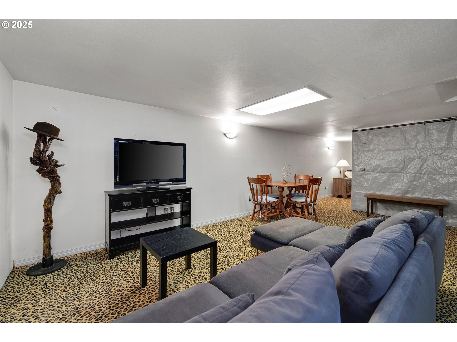 8815 Southwest Oleson Road Portland, OR 97223 - Photo 38 of 46 a living room with furniture and a flat screen tv
