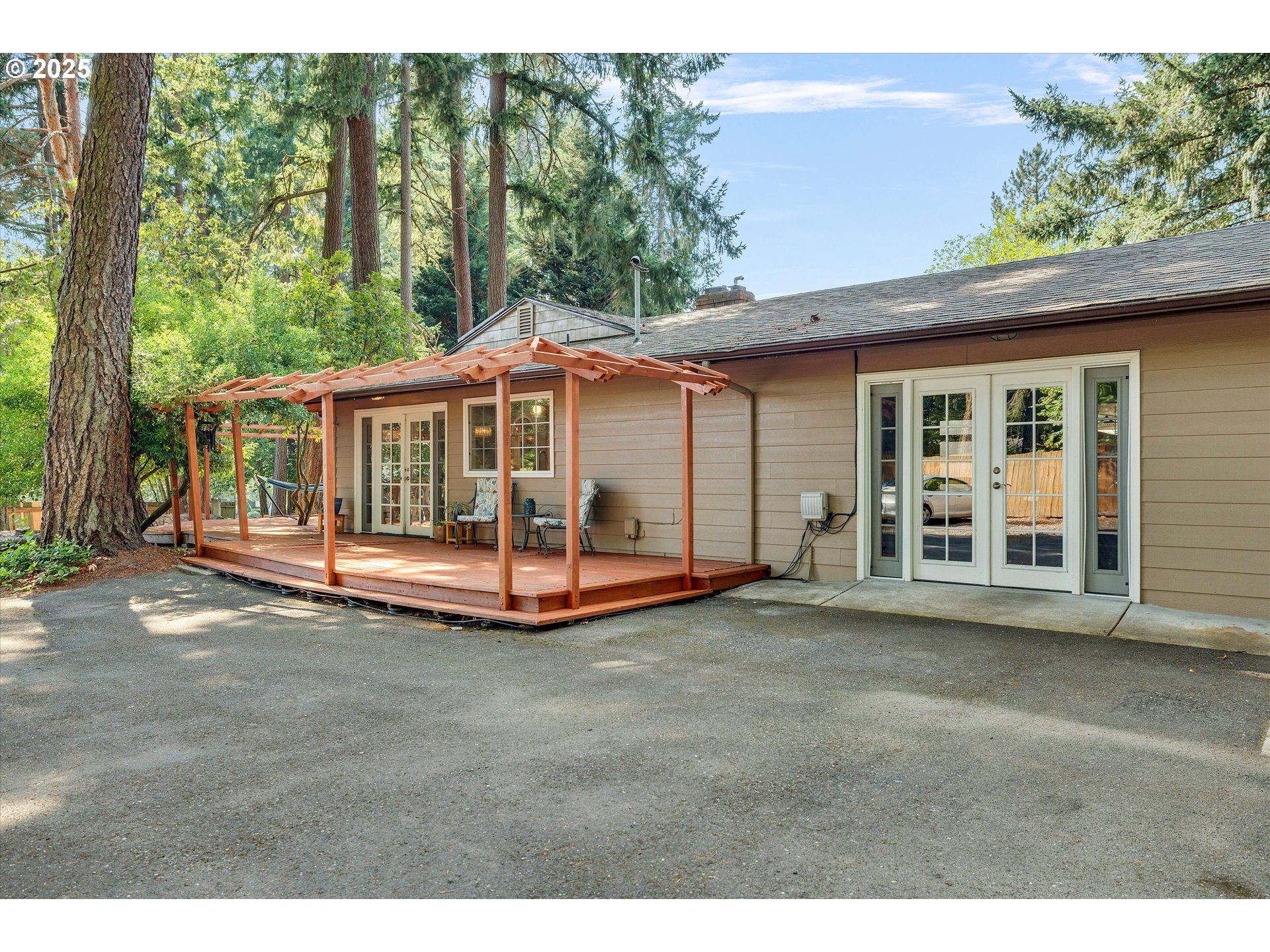 8815 Southwest Oleson Road Portland, OR 97223 - Photo 5 of 46 a view of a patio with a table and chairs under an umbrella