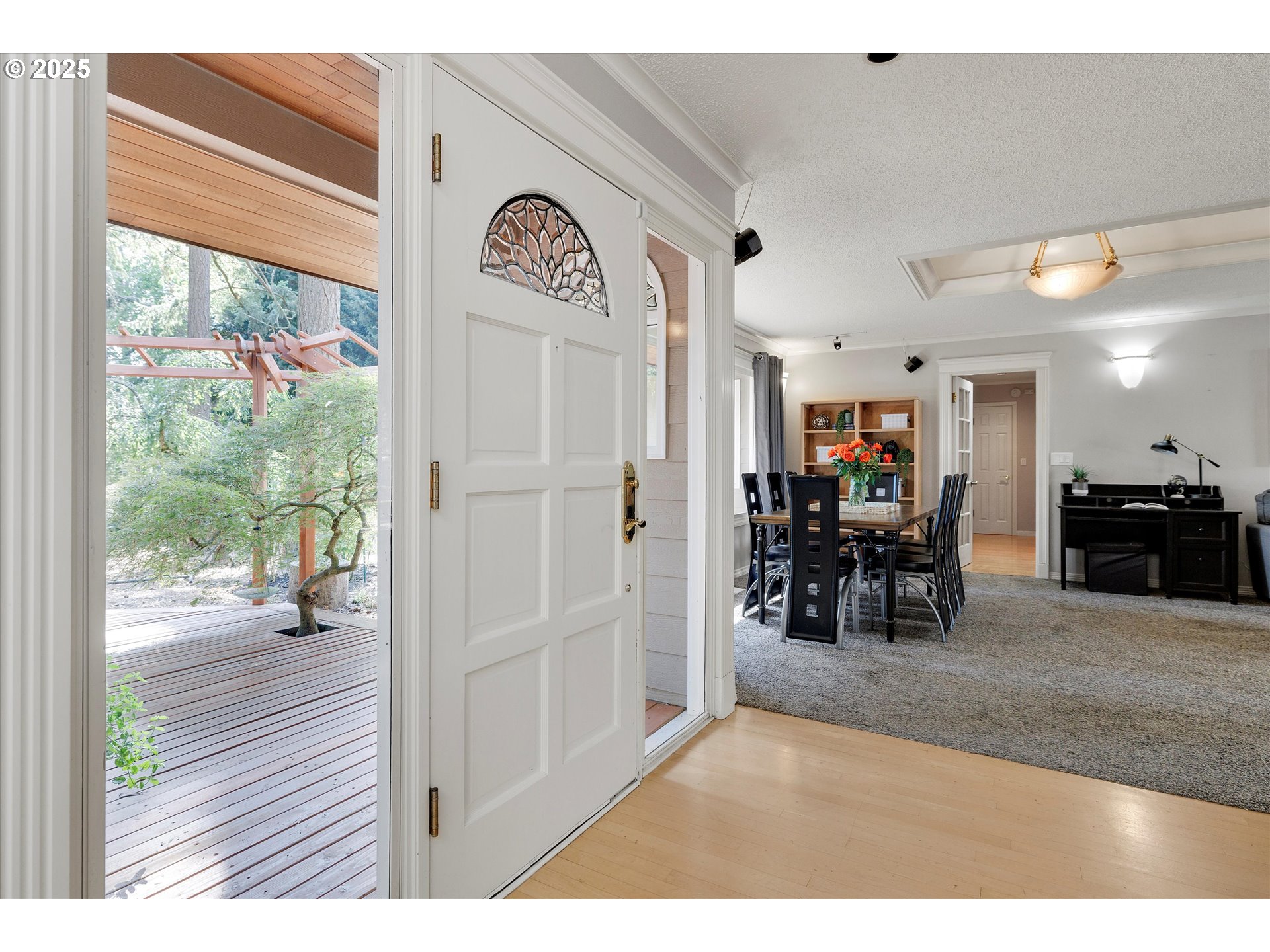 8815 Southwest Oleson Road Portland, OR 97223 - Photo 8 of 46 a view of a hallway with a dining table and chairs