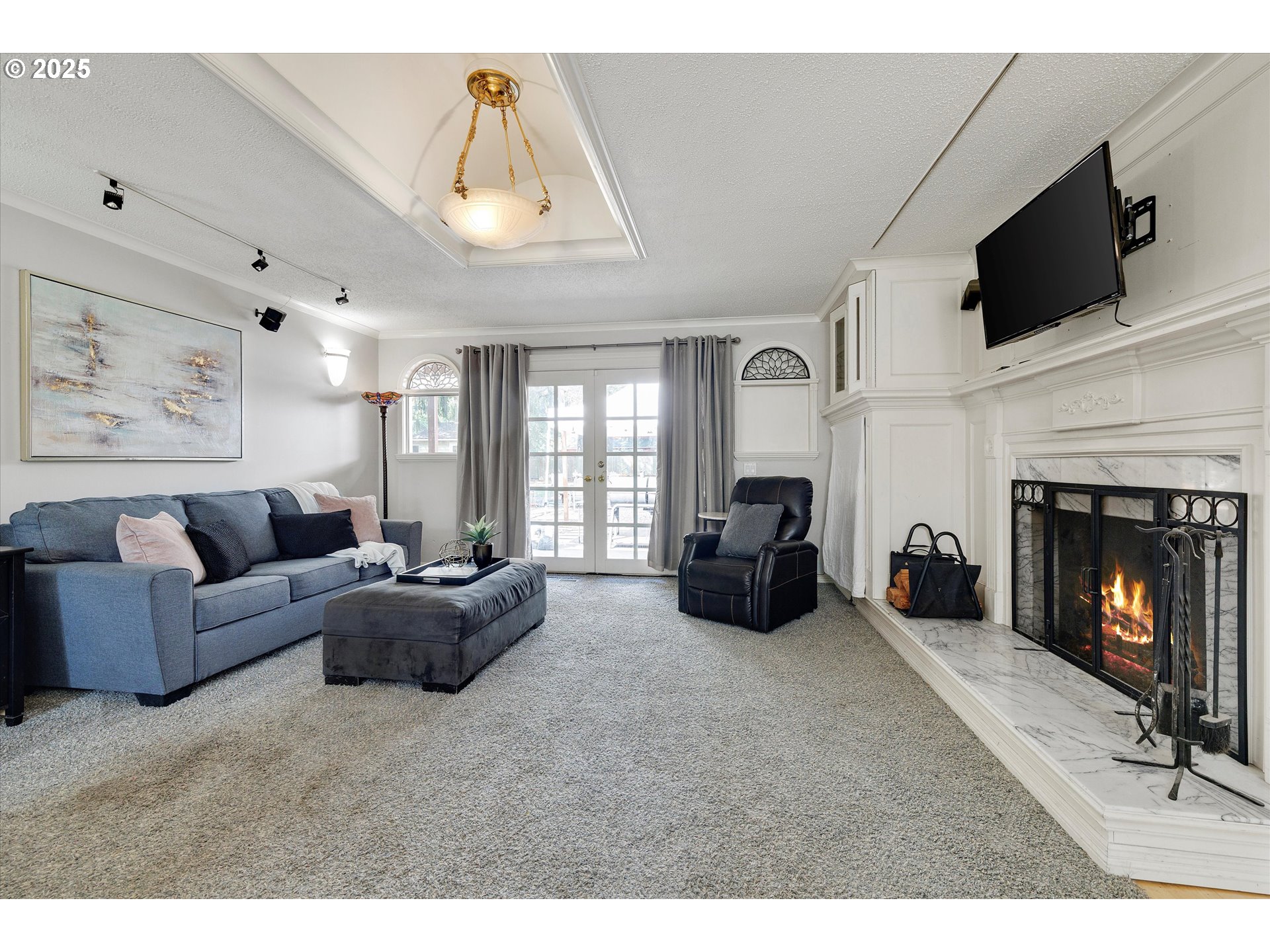 8815 Southwest Oleson Road Portland, OR 97223 - Photo 9 of 46 a living room with furniture a fireplace and a flat screen tv