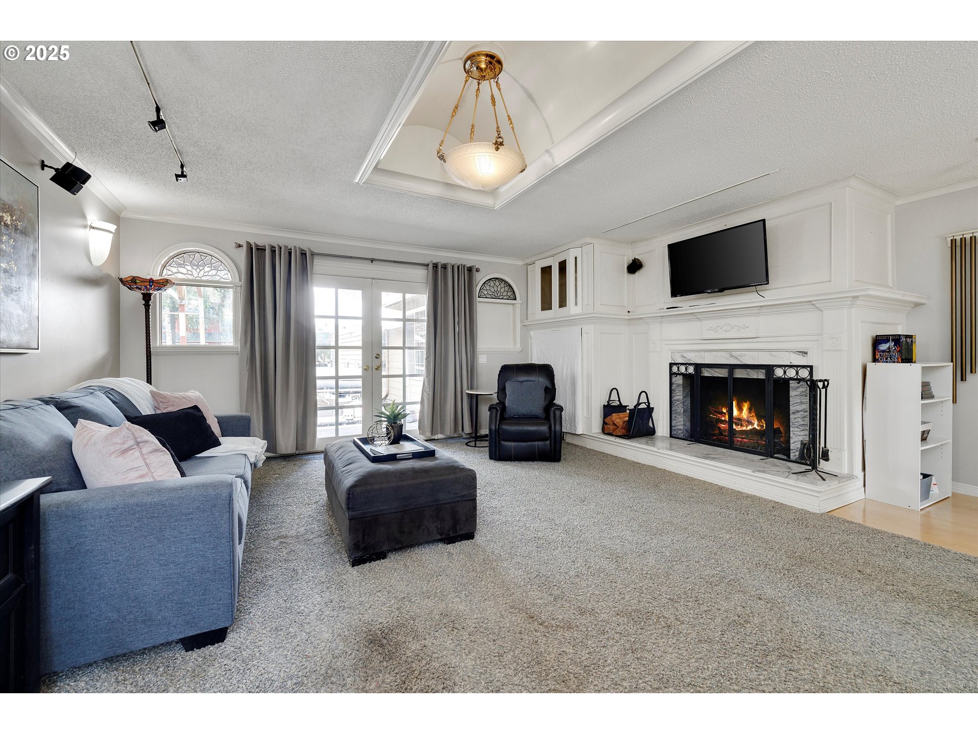 8815 Southwest Oleson Road Portland, OR 97223 - Photo 10 of 46 a living room with furniture a fireplace and a flat screen tv