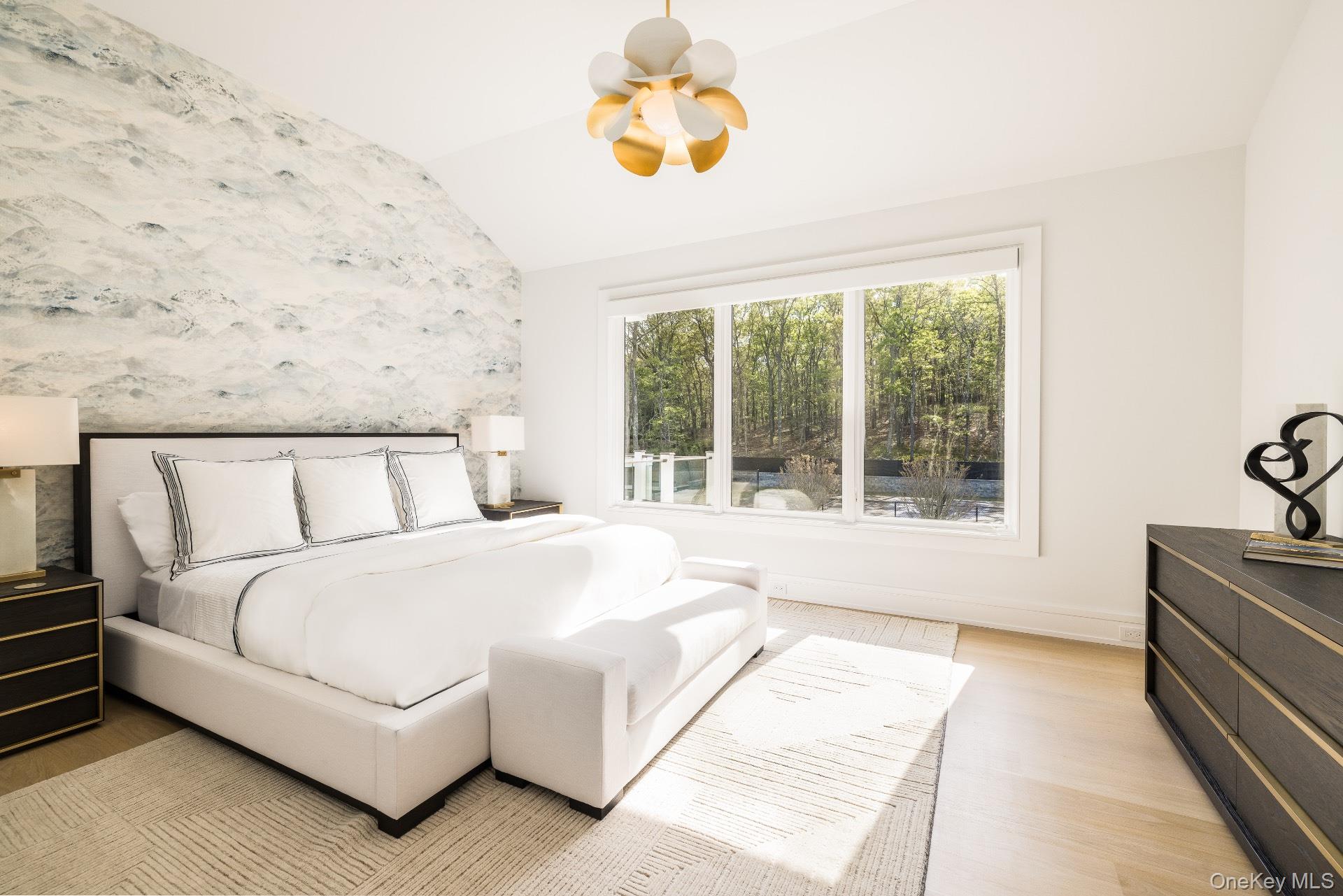 1552 Deerfield Road Water Mill, NY 11976 - Photo 20 of 37 a spacious bedroom with a bed and a couch