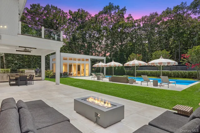 a view of a house with backyard sitting area and garden