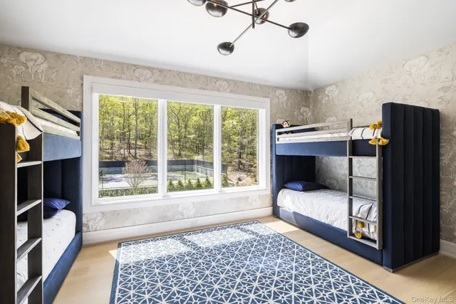 a living room with furniture a flat screen tv and a large window
