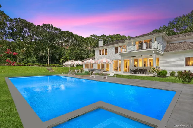 a view of a house with pool and a yard