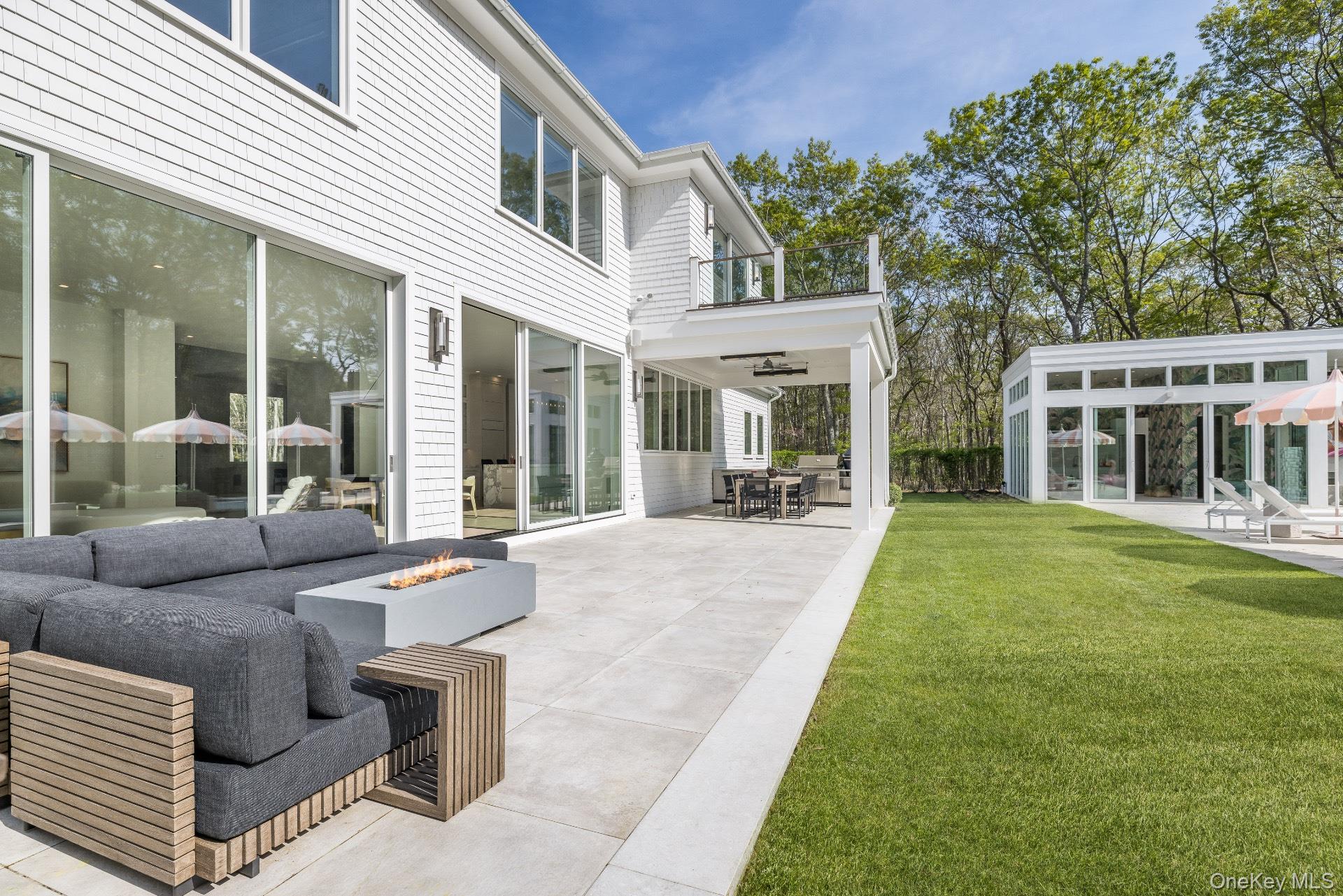 1552 Deerfield Road Water Mill, NY 11976 - Photo 8 of 37 a view of a patio with couches table and chairs and potted plants