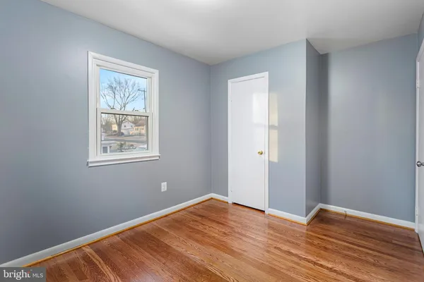 a view of room with wooden floor and window