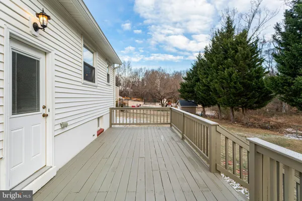 a view of a balcony with wooden floor