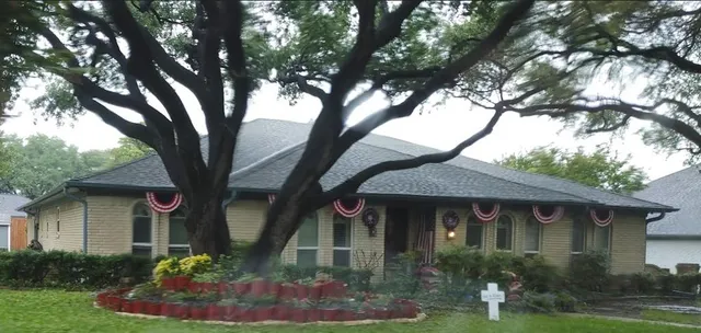 a front view of a house with garden