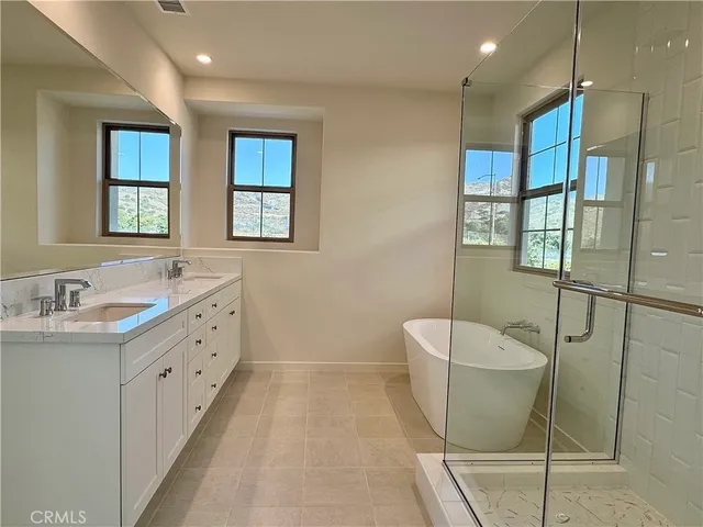 a bathroom with double sink and a mirror