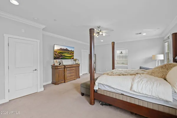 a spacious bedroom with a bed and dresser