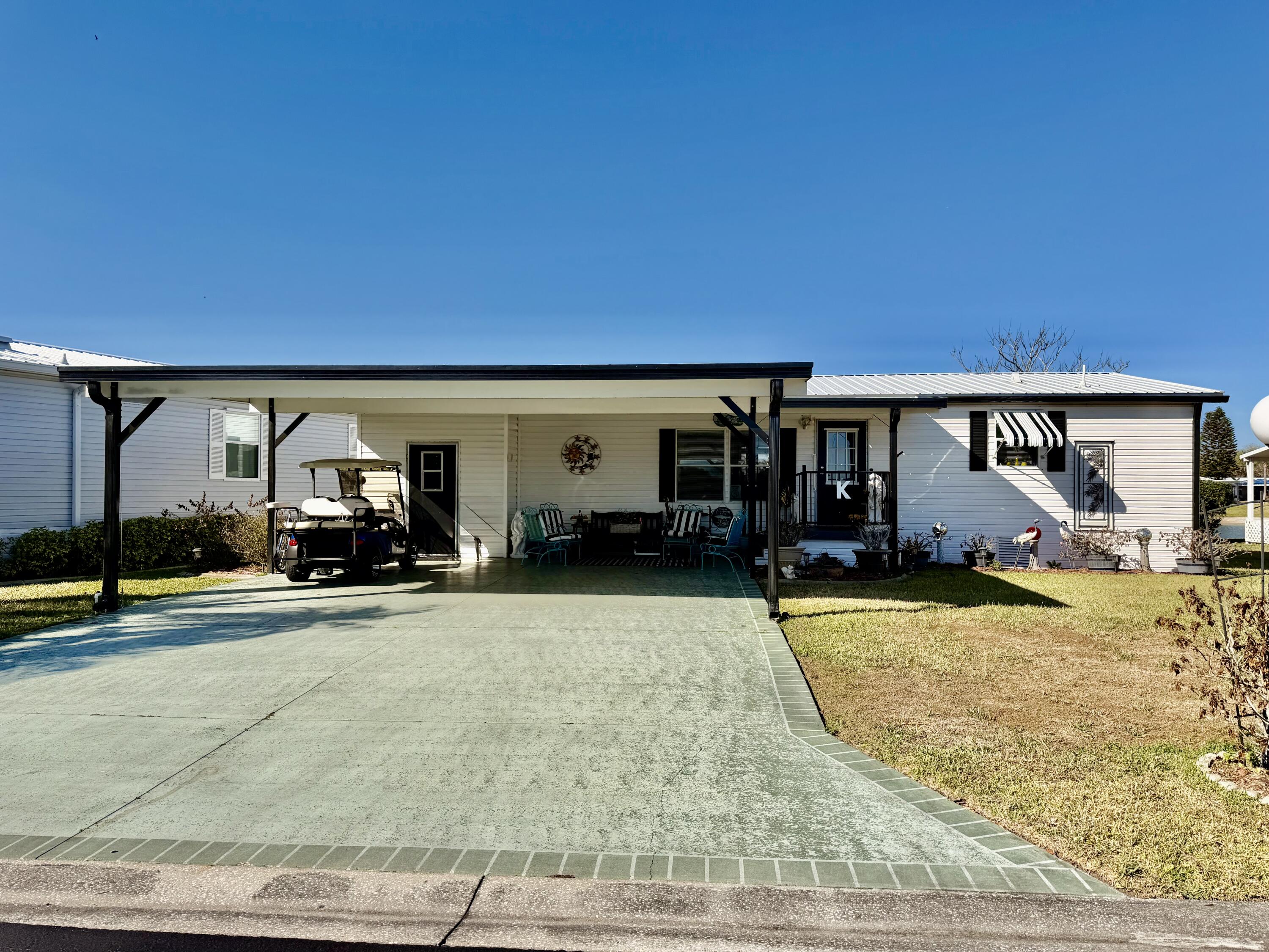 a view of a house with swimming pool and porch