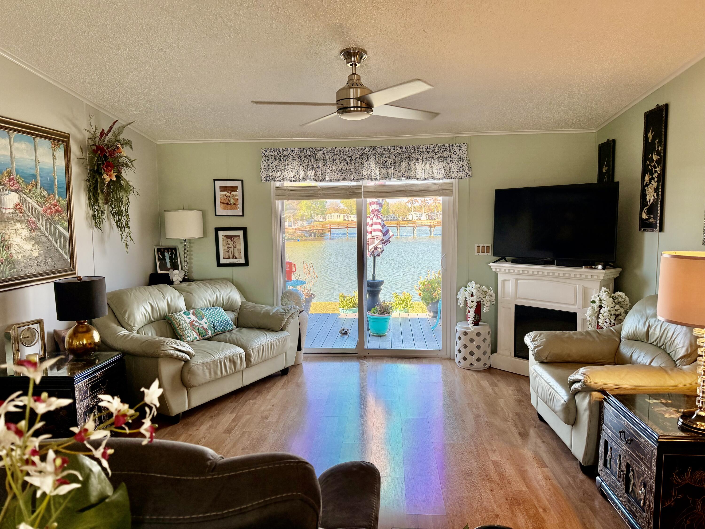 1692 Southwest 35th Circle Okeechobee, FL 34974 - Photo 16 of 30 a living room with fireplace furniture and a flat screen tv
