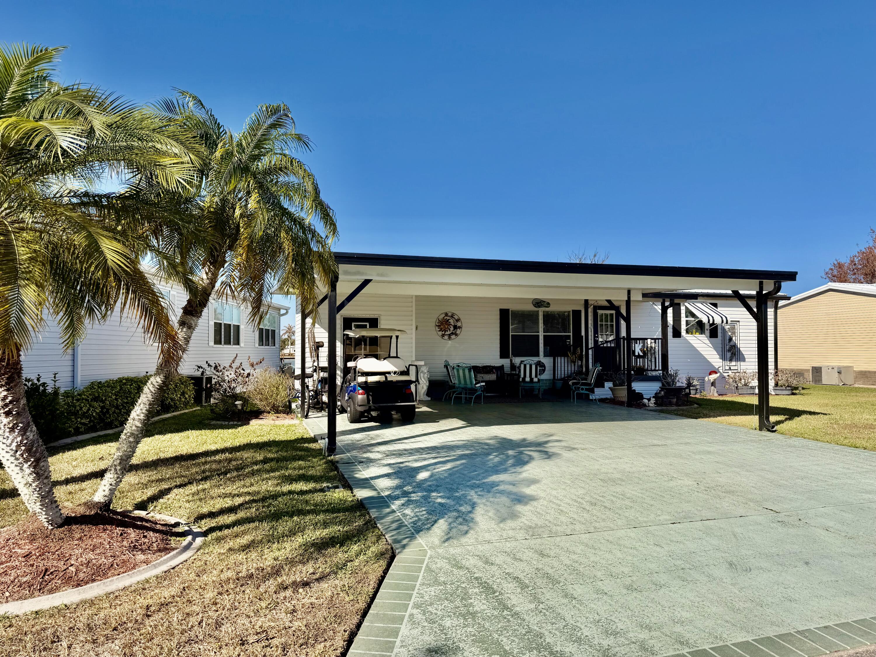 1692 Southwest 35th Circle Okeechobee, FL 34974 - Photo 18 of 30 a view of a house with backyard porch and sitting area