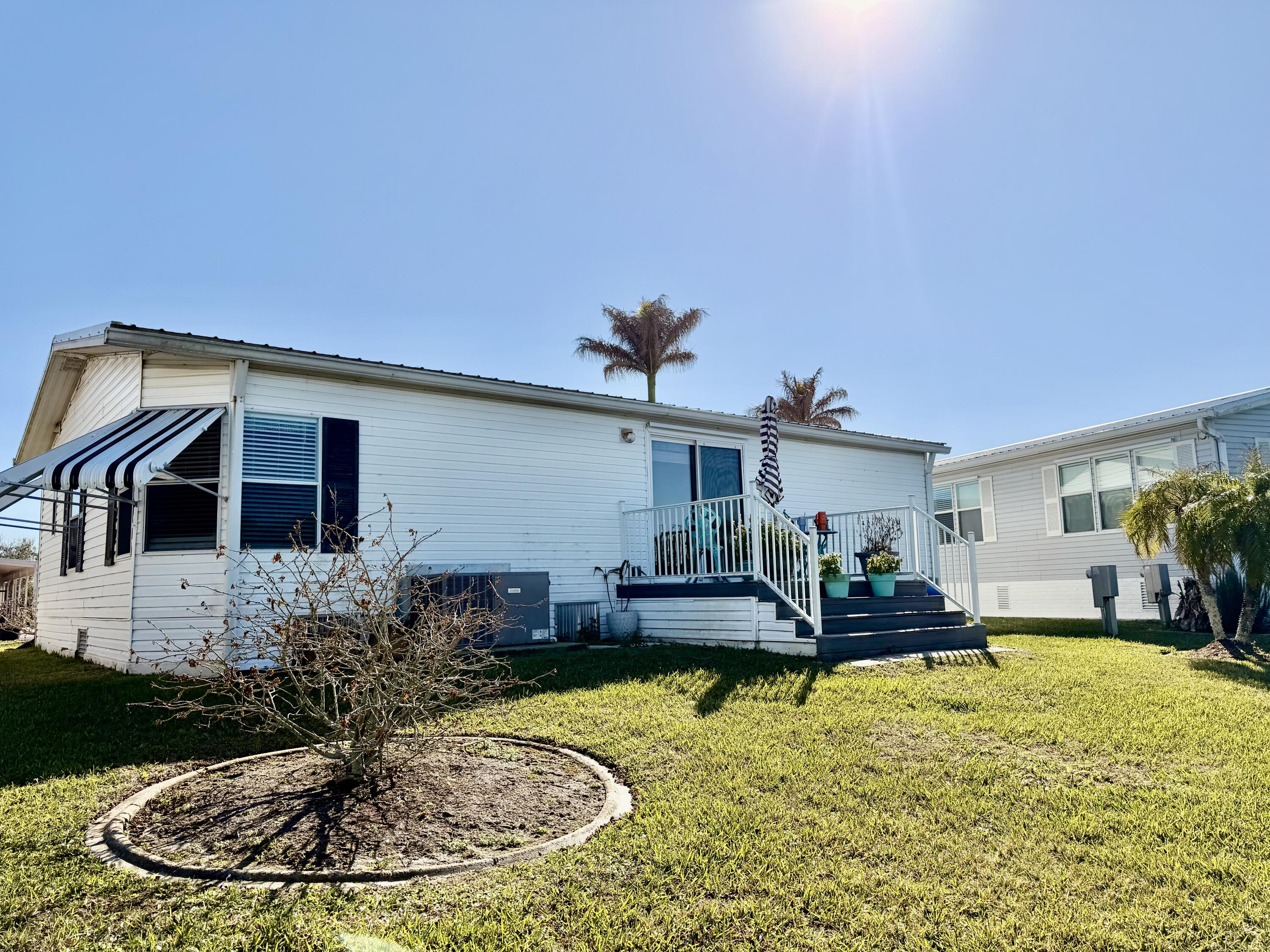 1692 Southwest 35th Circle Okeechobee, FL 34974 - Photo 22 of 30 a view of a house with swimming pool and a yard