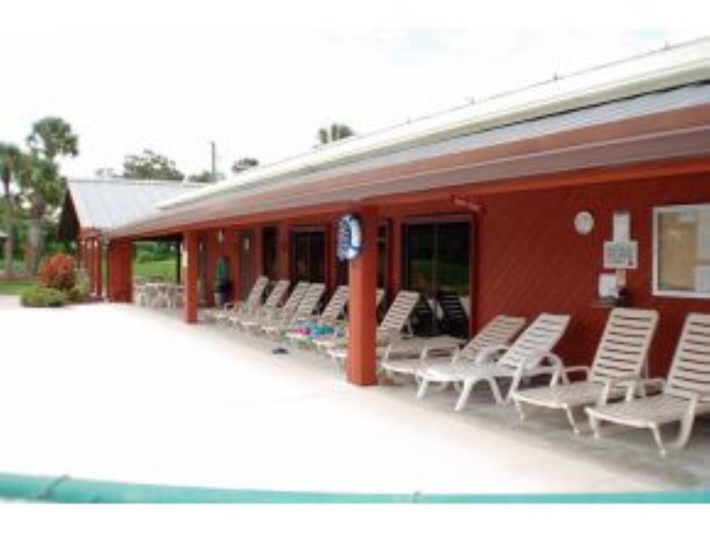 1692 Southwest 35th Circle Okeechobee, FL 34974 - Photo 30 of 30 a view of a patio with table and chairs and potted plants