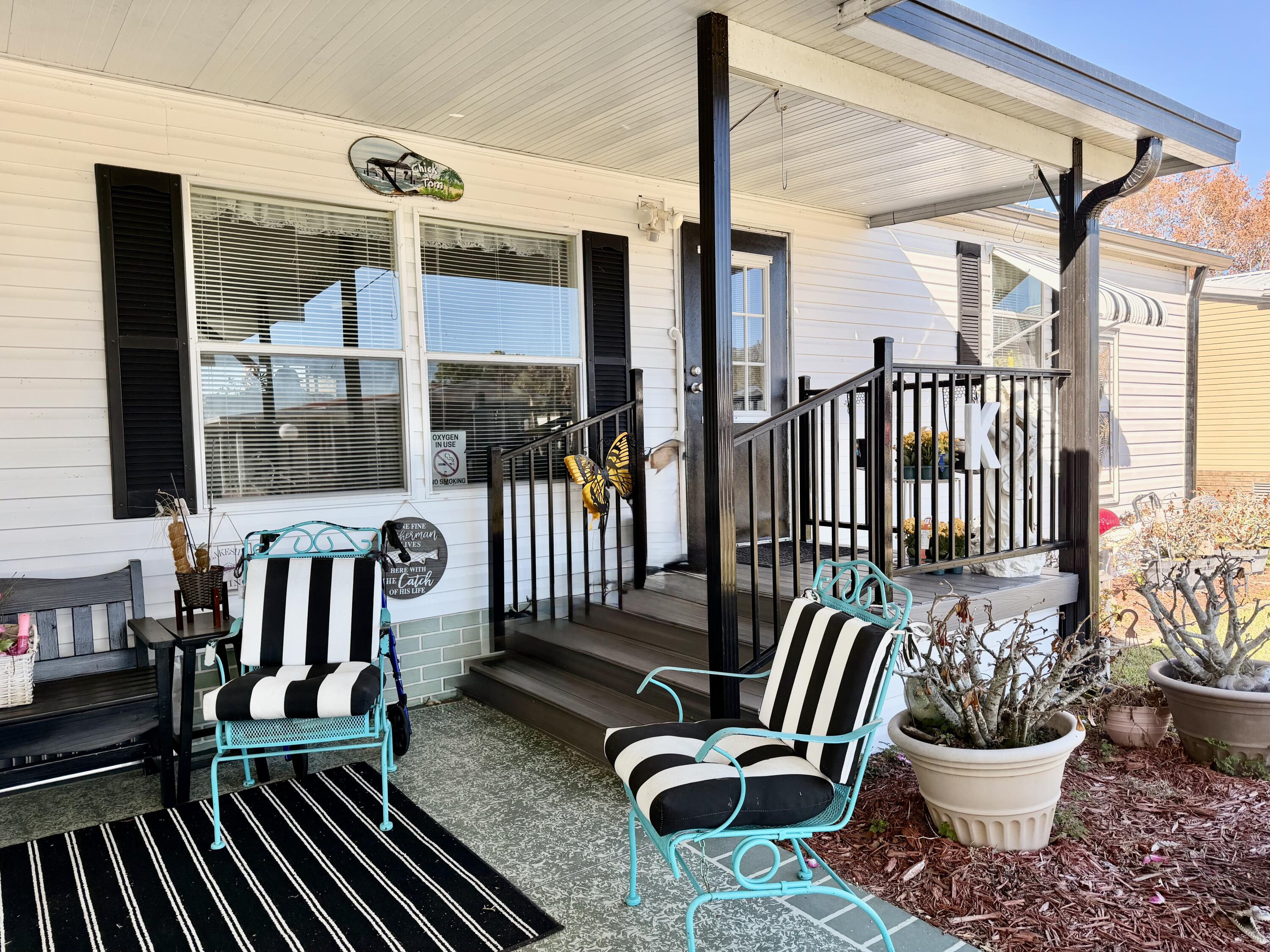 1692 Southwest 35th Circle Okeechobee, FL 34974 - Photo 3 of 30 a view of a balcony with chairs and a potted plant