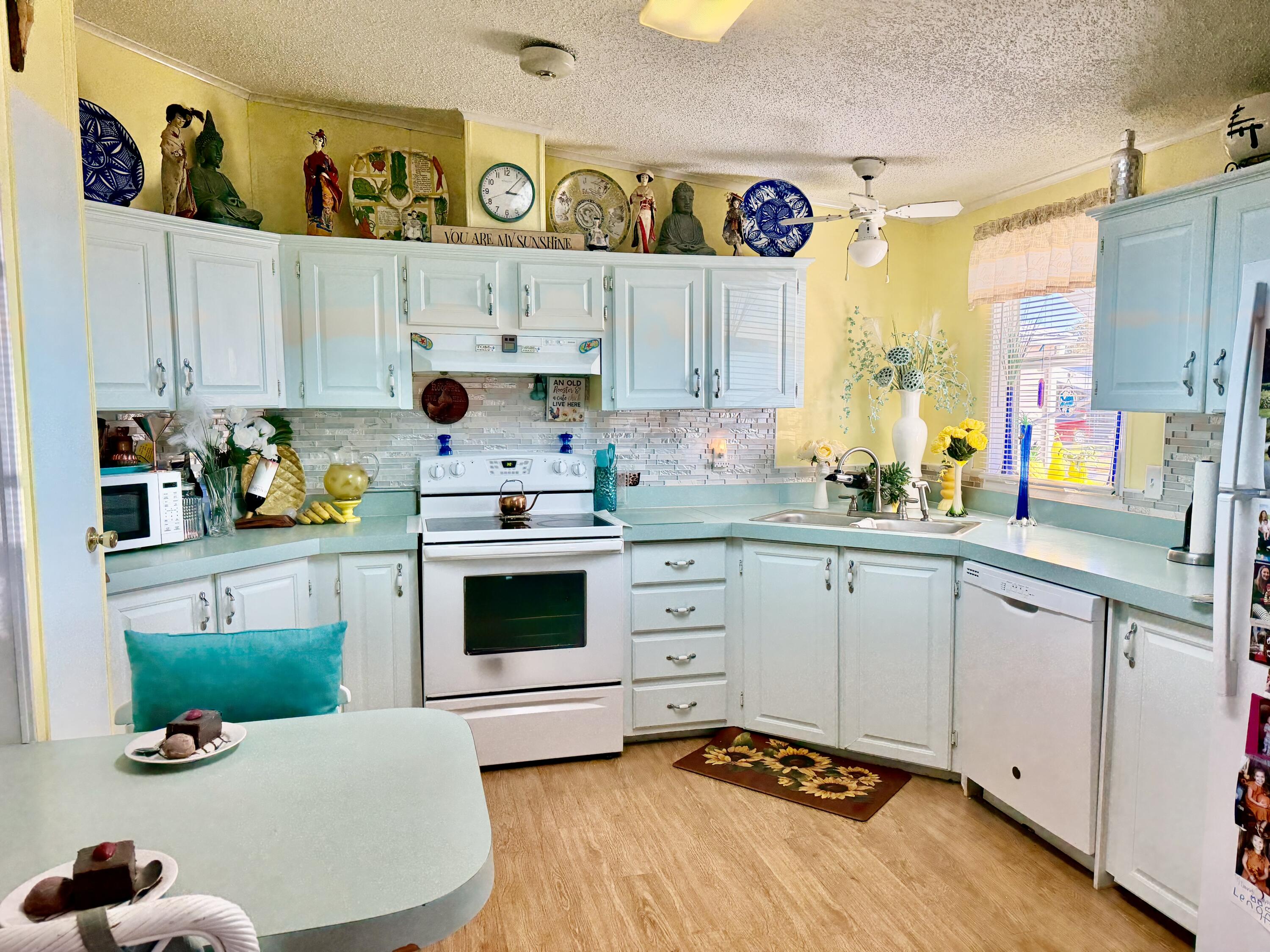 1692 Southwest 35th Circle Okeechobee, FL 34974 - Photo 5 of 30 a kitchen with a white cabinets and window