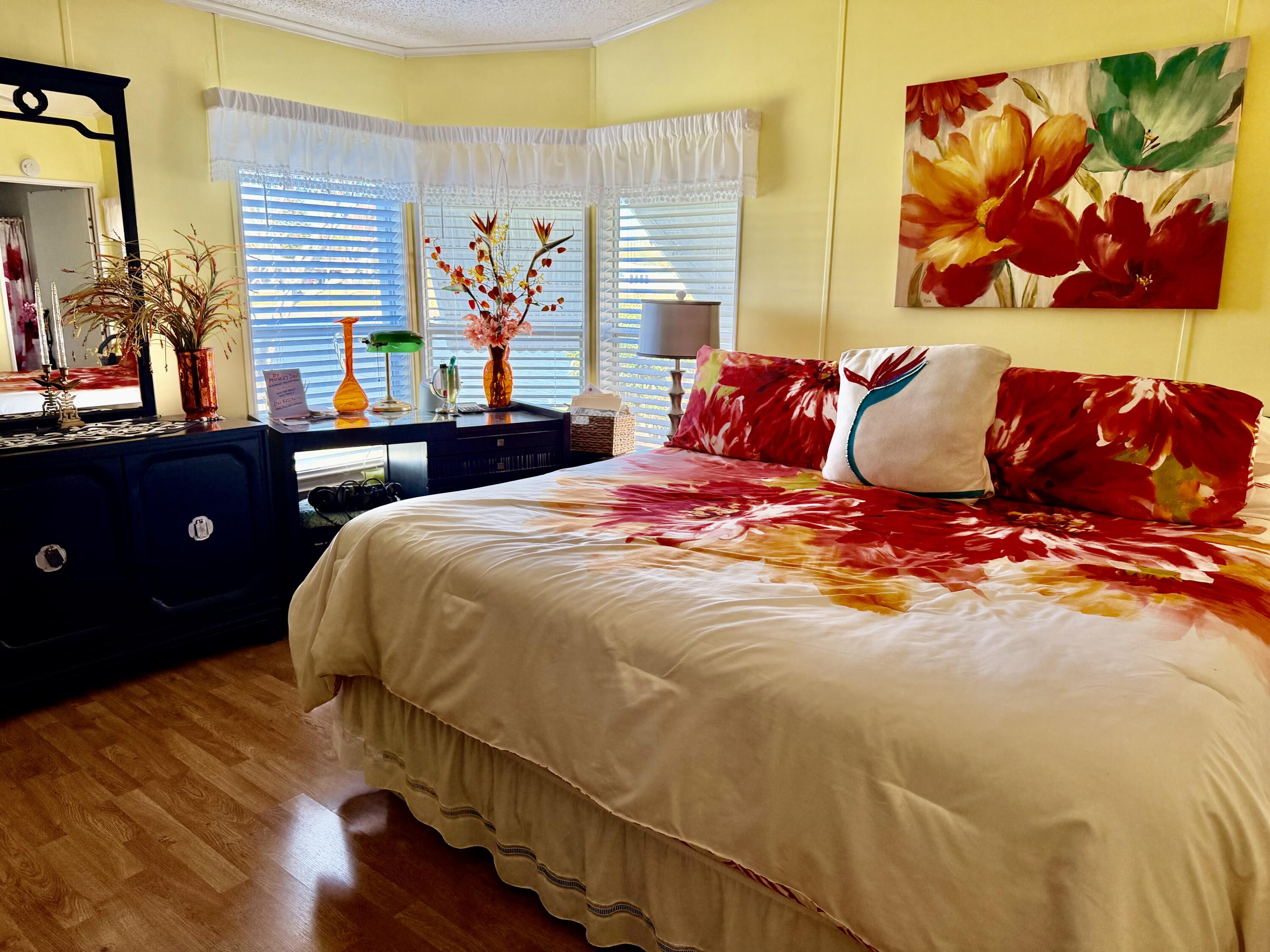 1692 Southwest 35th Circle Okeechobee, FL 34974 - Photo 7 of 30 a bedroom with a bed and a painting on the wall