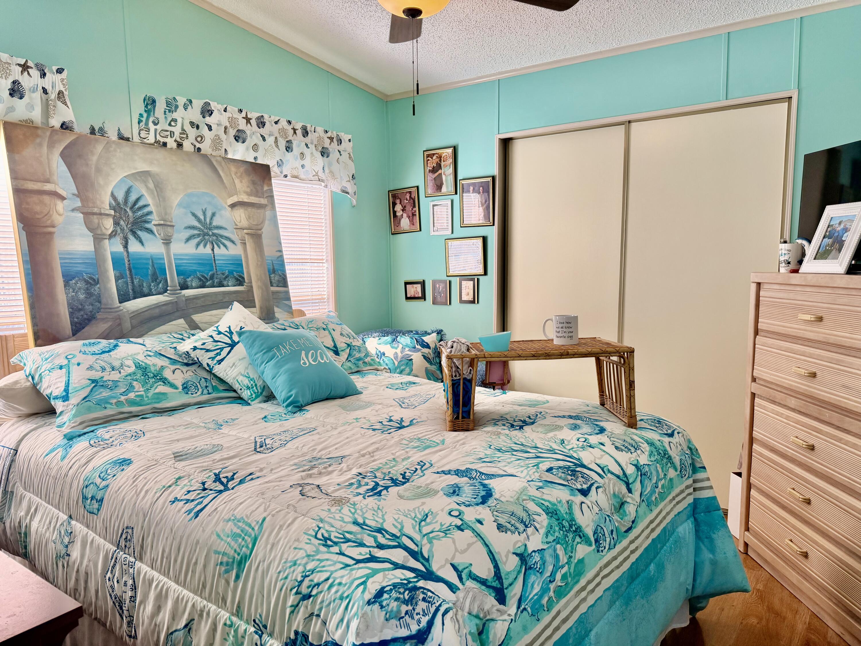 1692 Southwest 35th Circle Okeechobee, FL 34974 - Photo 9 of 30 a bedroom with a bed a dresser and a large mirror