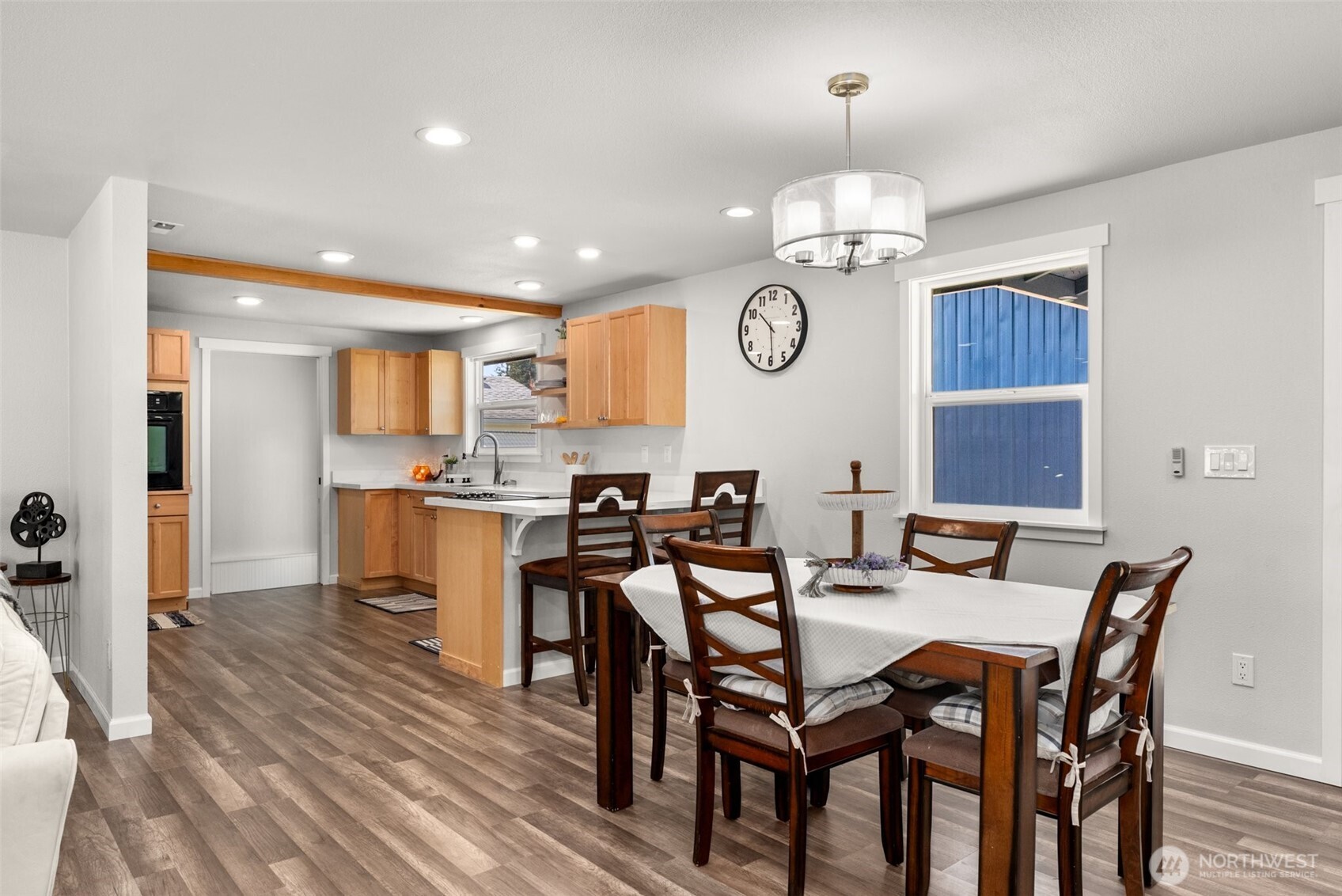 9037 178th Avenue Southwest Rochester, WA 98579 - Photo 11 of 33 a view of a dining room with furniture a chandelier and wooden floor