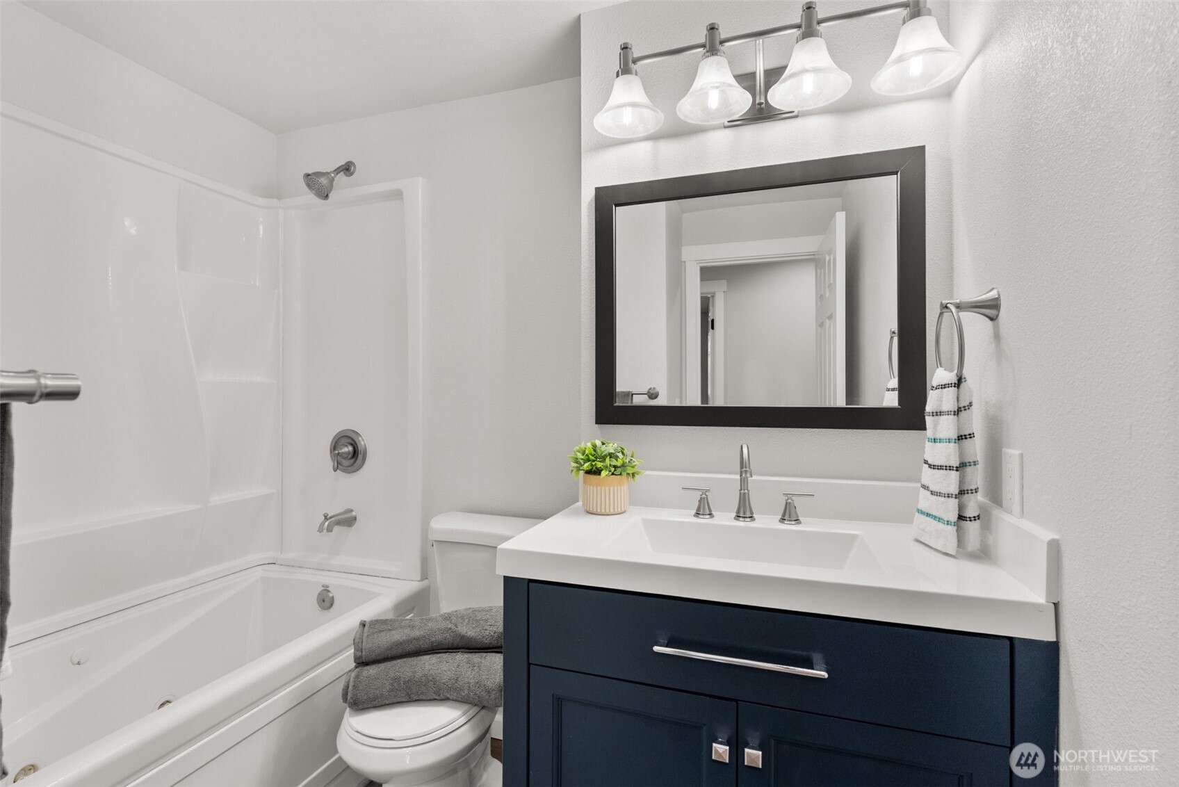 9037 178th Avenue Southwest Rochester, WA 98579 - Photo 14 of 33 a bathroom with a toilet sink vanity tub and mirror