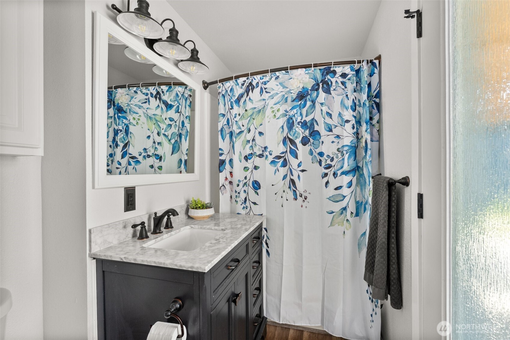 9037 178th Avenue Southwest Rochester, WA 98579 - Photo 18 of 33 a bathroom with a granite countertop sink a mirror a shower and a window