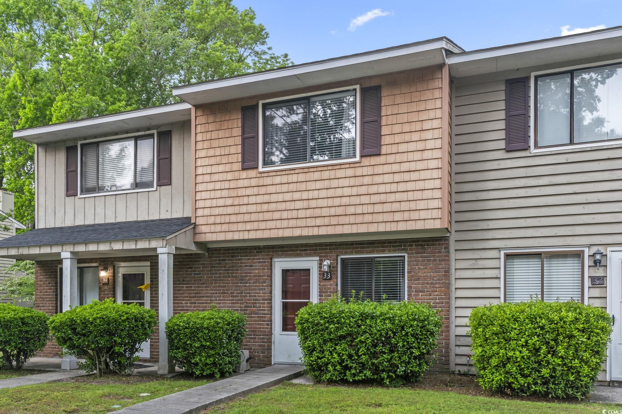 View of front of property with brick siding