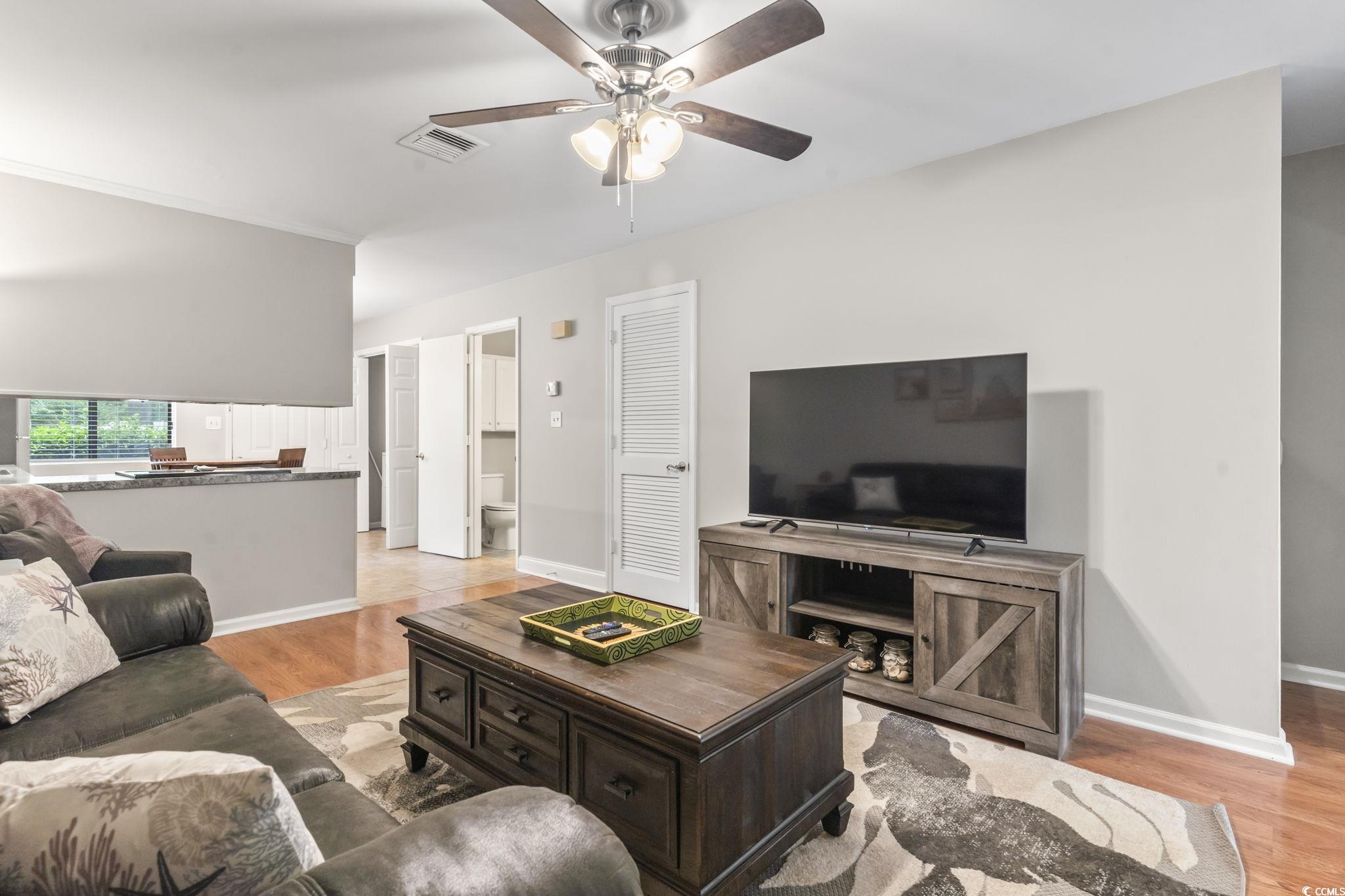 86 Beaver Pond Loop, Unit 33 Pawleys Island, SC 29585 - Photo 10 of 25 Living room with light wood-type flooring and ceiling fan