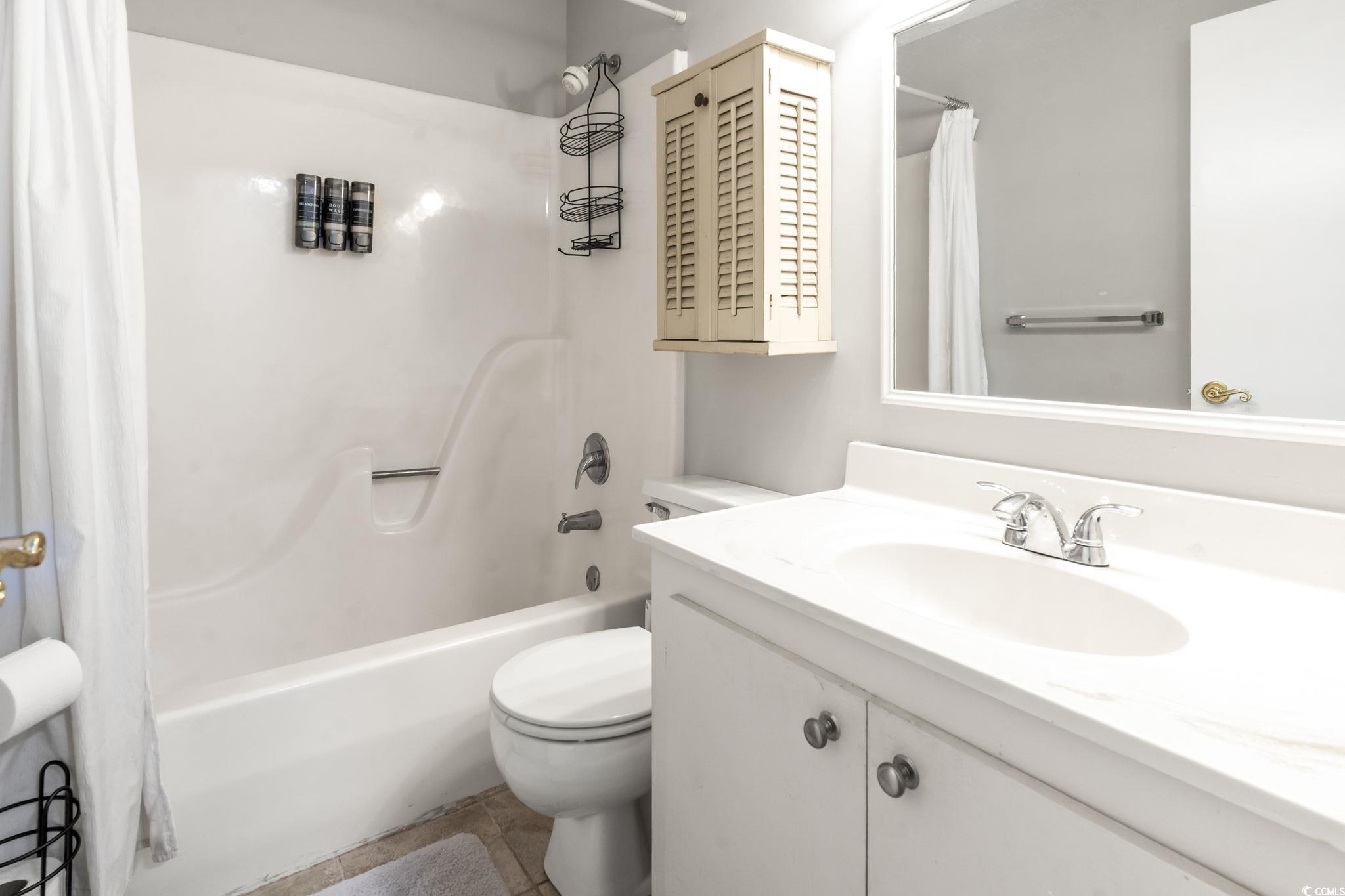 86 Beaver Pond Loop, Unit 33 Pawleys Island, SC 29585 - Photo 16 of 25 Full bathroom with vanity, shower / bath combination with curtain, and light tile patterned floors