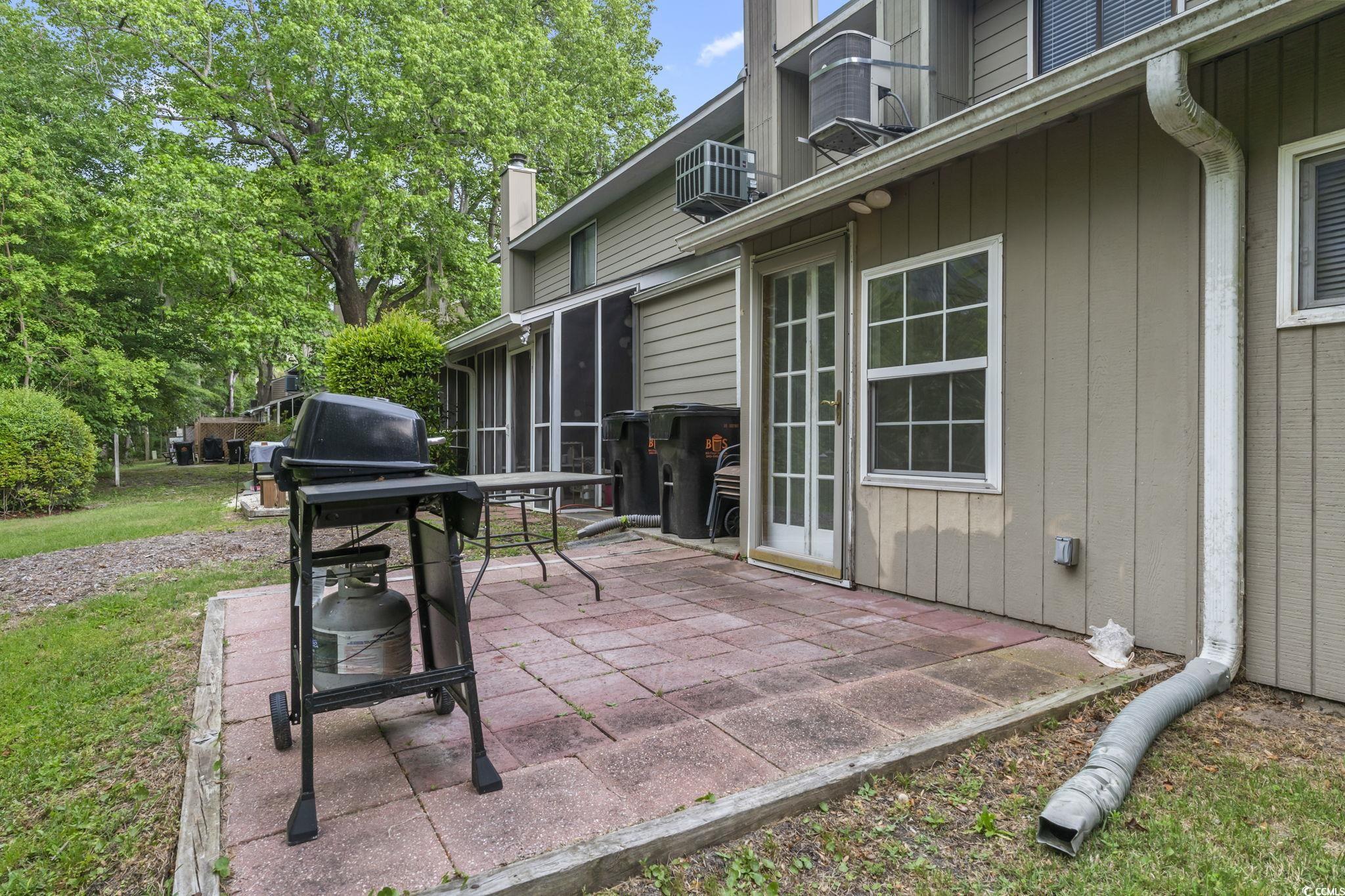 86 Beaver Pond Loop, Unit 33 Pawleys Island, SC 29585 - Photo 22 of 25 View of patio / terrace featuring a sunroom, grilling area, and a wall mounted air conditioner