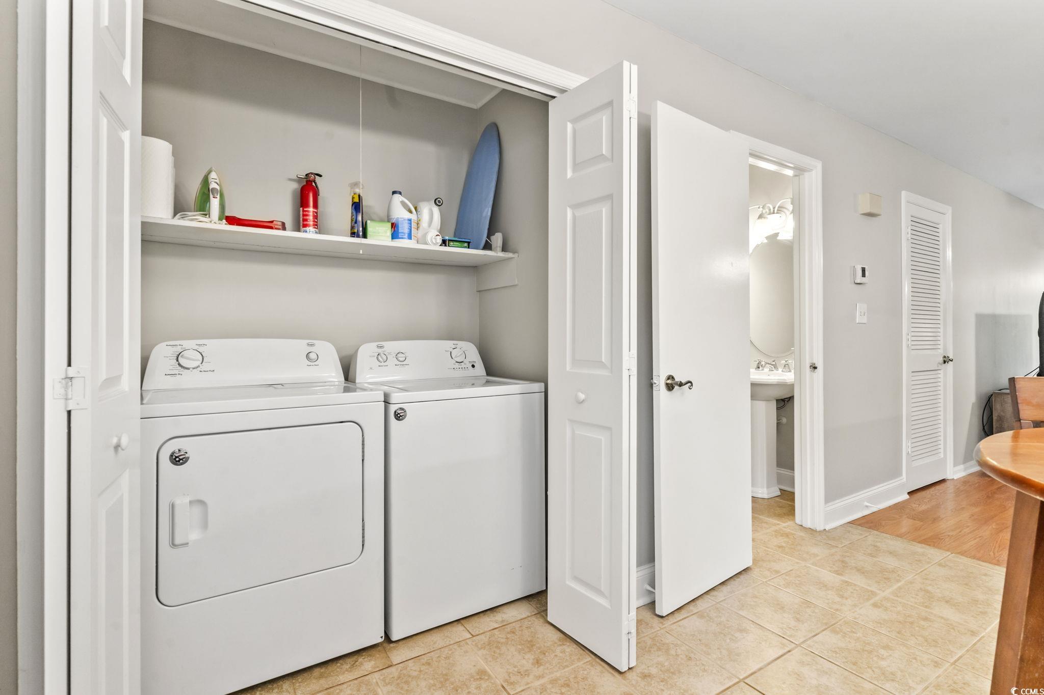 86 Beaver Pond Loop, Unit 33 Pawleys Island, SC 29585 - Photo 5 of 25 Washroom featuring light tile patterned floors and washer and dryer