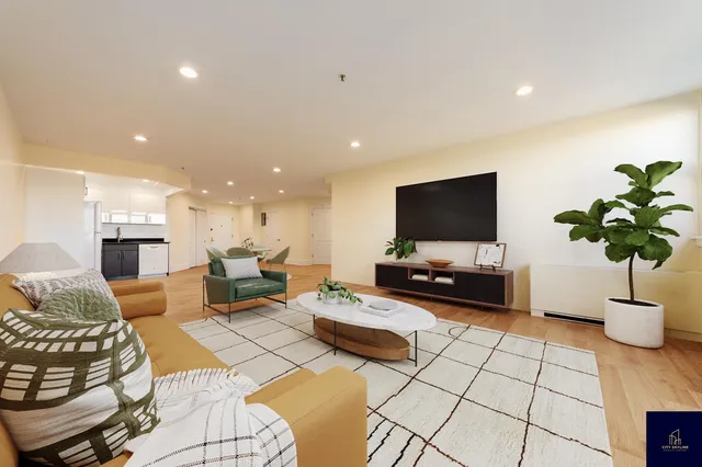 a kitchen with stainless steel appliances kitchen island granite countertop a refrigerator and a stove top oven