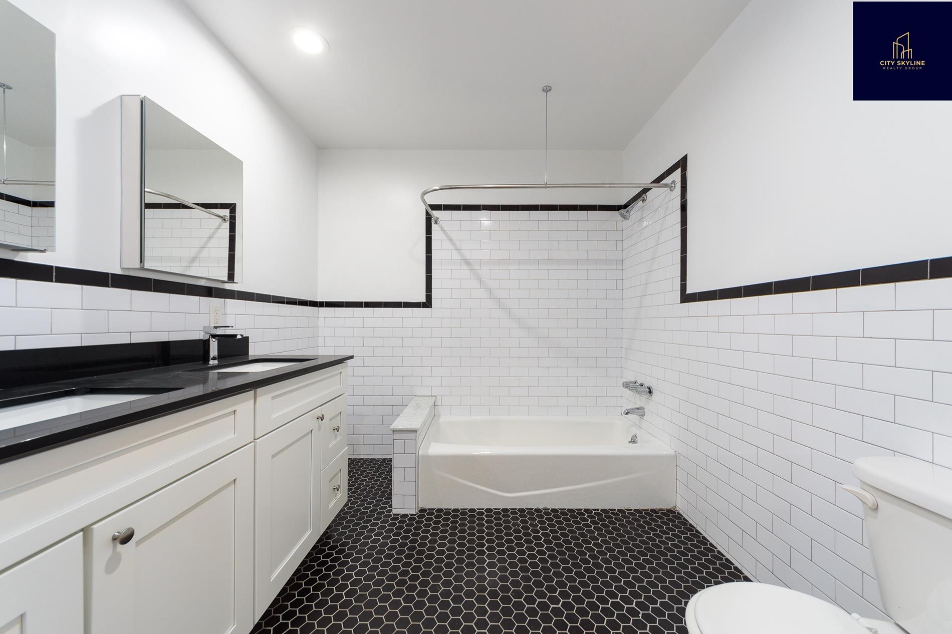 19-19 24th Avenue, Unit L706 Queens, NY 11102 - Photo 8 of 19 a bathroom with a sink a toilet and shower