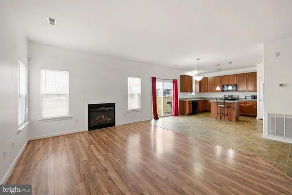 a view of kitchen with furniture and wooden floor