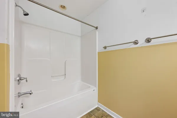 a bathroom with a shower and a bath tub