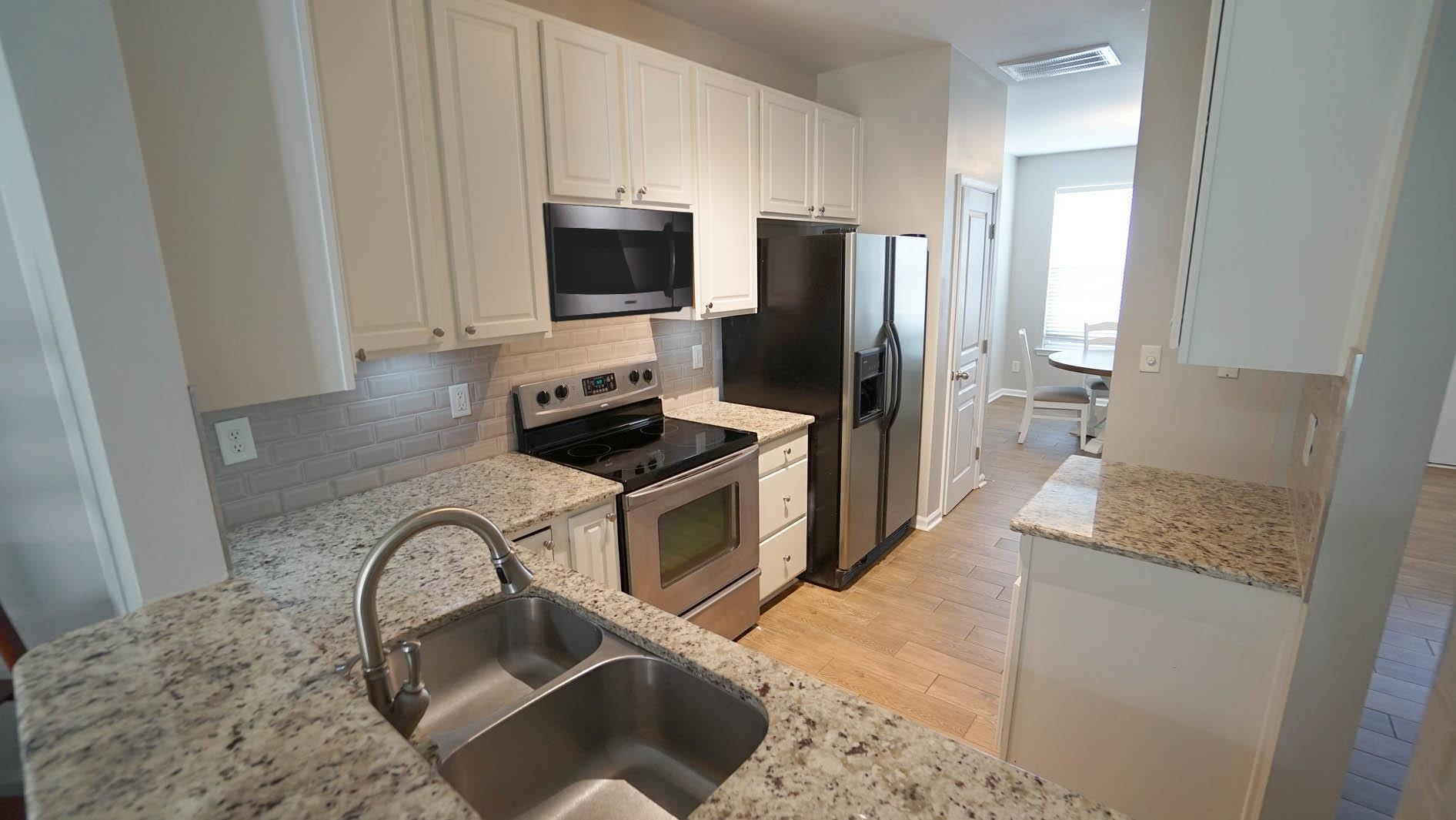 7842 Silverthread Lane Raleigh, NC 27617 - Photo 7 of 26 *Kitchen w/ a View into Living Area*