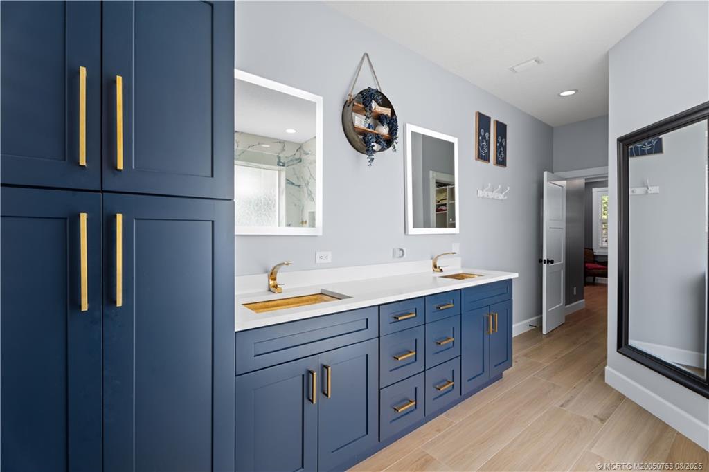 10 Copaire Road Stuart, FL 34996 - Photo 13 of 48 a bathroom with a double vanity sink and mirror