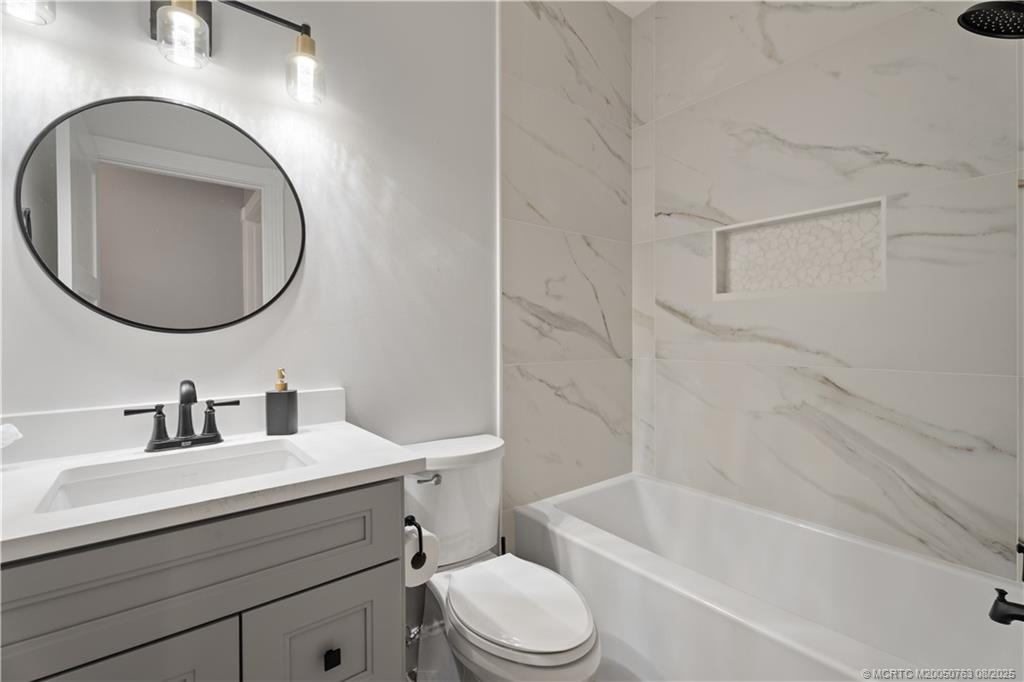 10 Copaire Road Stuart, FL 34996 - Photo 16 of 48 a bathroom with a sink toilet and a bathtub