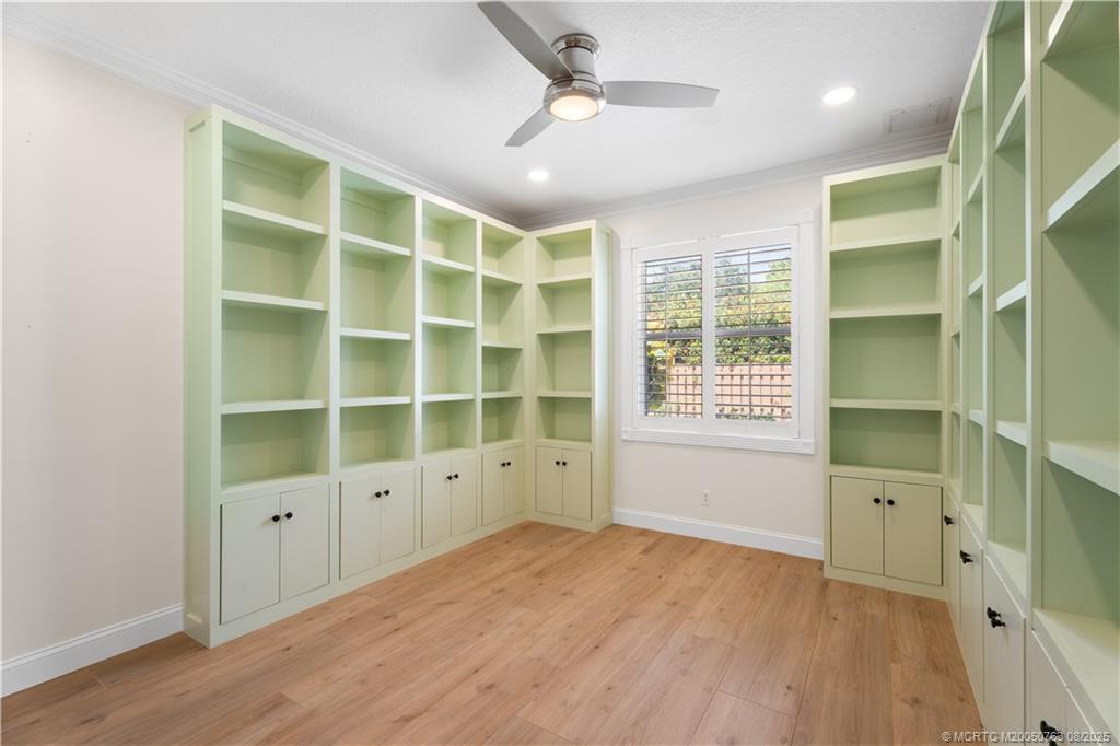10 Copaire Road Stuart, FL 34996 - Photo 22 of 48 a view of an empty room with a window and wooden floor