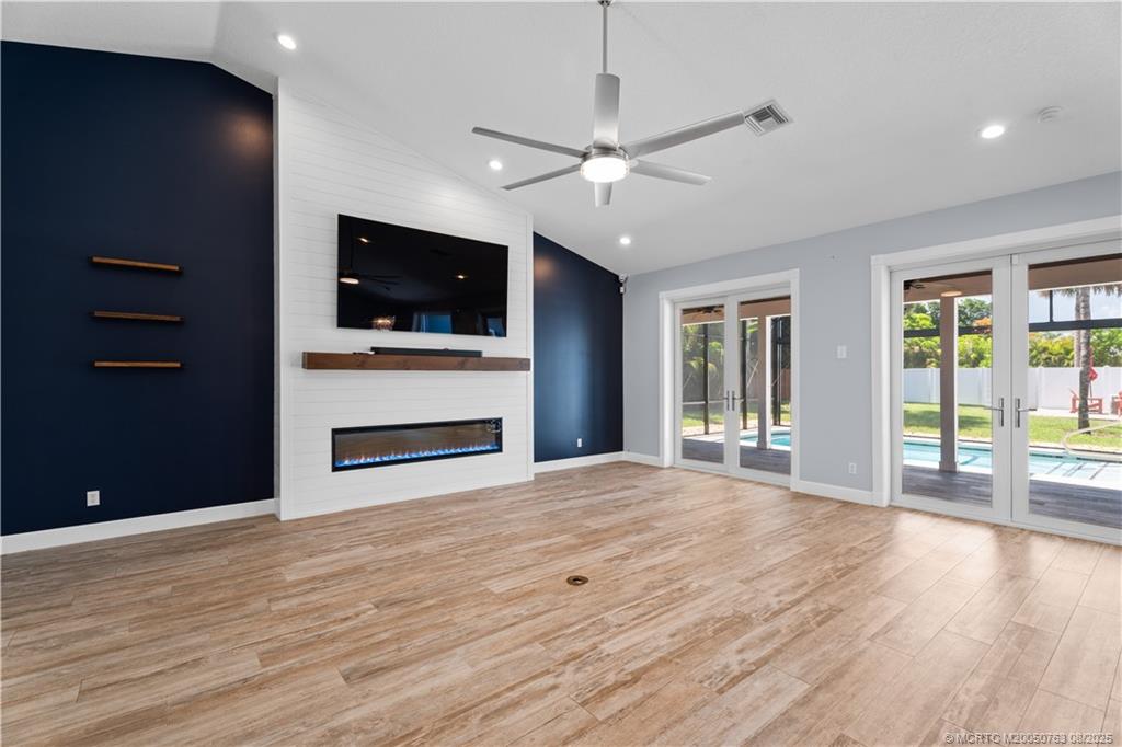 10 Copaire Road Stuart, FL 34996 - Photo 25 of 48 a view of livingroom with flat screen tv fire place and windows