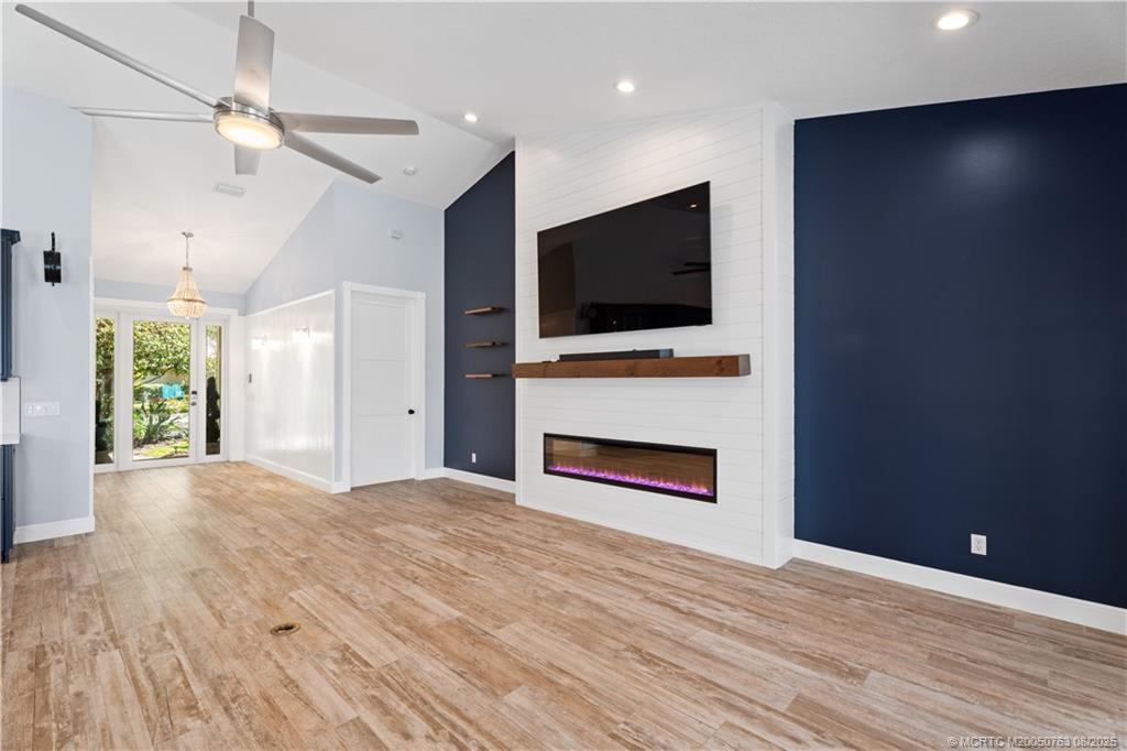 10 Copaire Road Stuart, FL 34996 - Photo 28 of 48 a view of a livingroom with a fireplace a ceiling fan and wooden floor
