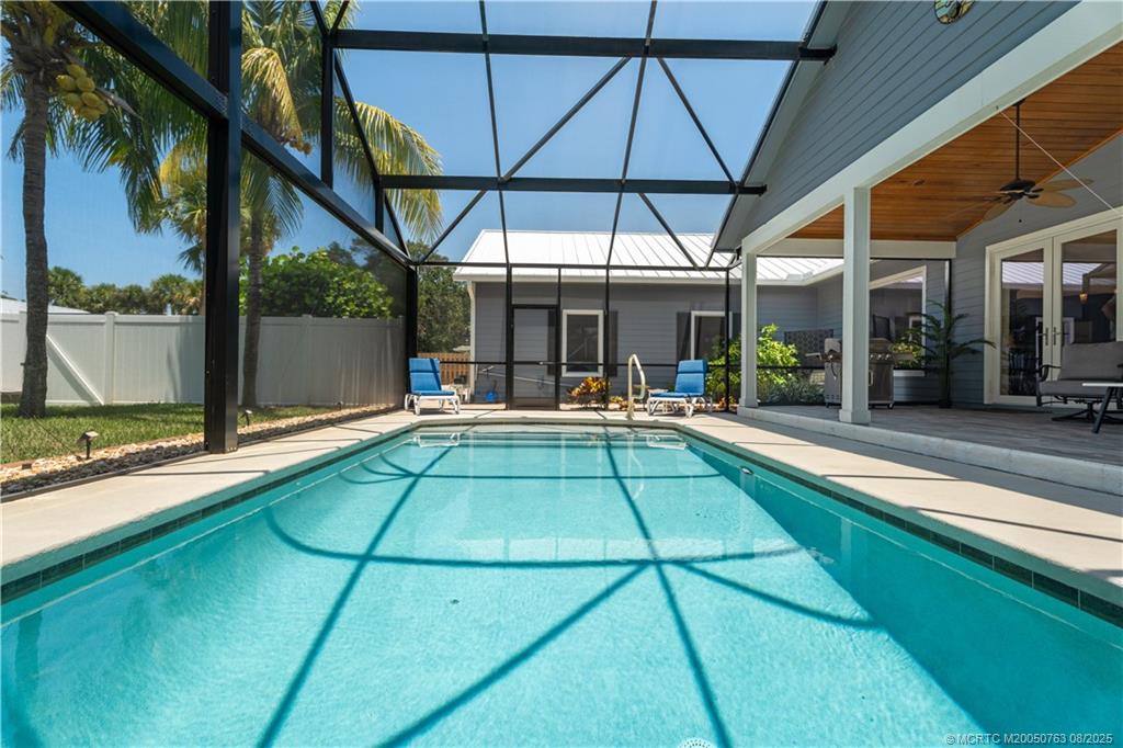 10 Copaire Road Stuart, FL 34996 - Photo 31 of 48 a view of a patio with a table and chairs under an umbrella