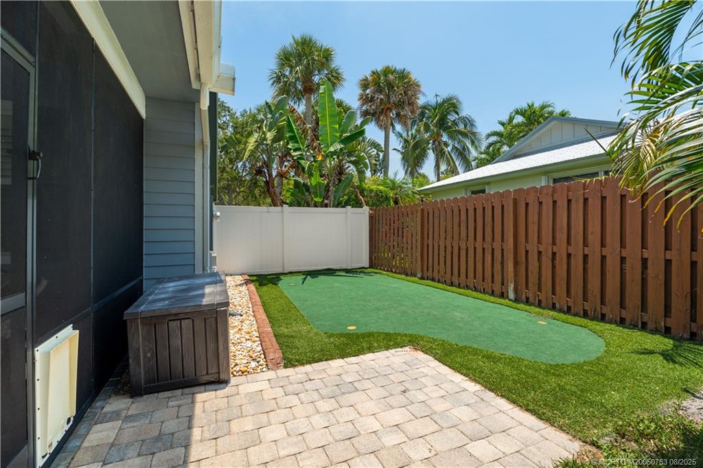 10 Copaire Road Stuart, FL 34996 - Photo 38 of 48 a view of a backyard with door and outdoor seating