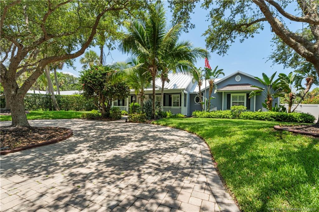 10 Copaire Road Stuart, FL 34996 - Photo 42 of 48 a view of house in front of a big yard with large trees
