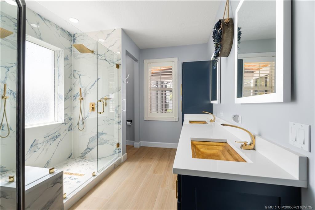 10 Copaire Road Stuart, FL 34996 - Photo 6 of 48 a bathroom with a tub sink and mirror